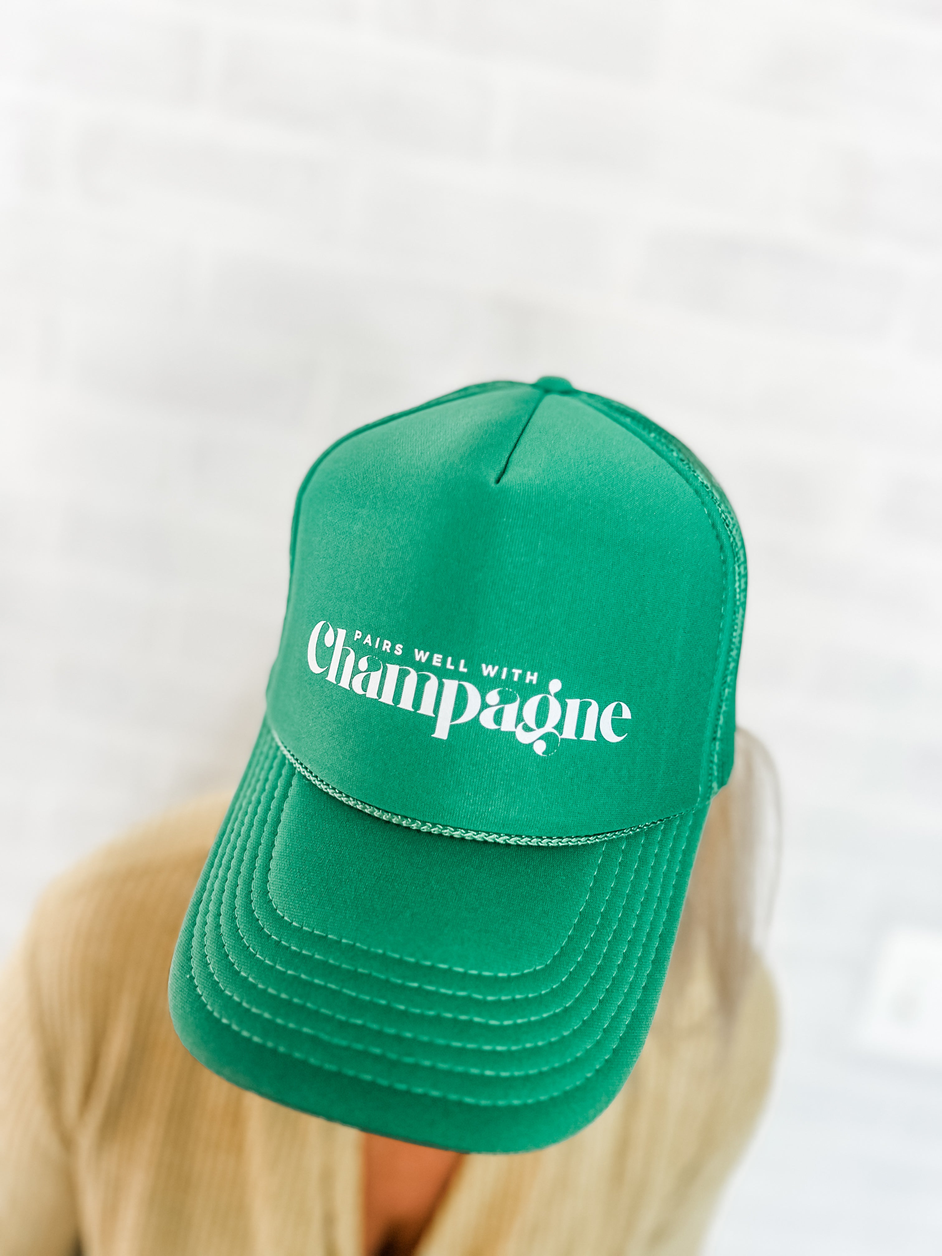 pairs well with champagne green foam corkie trucker hat