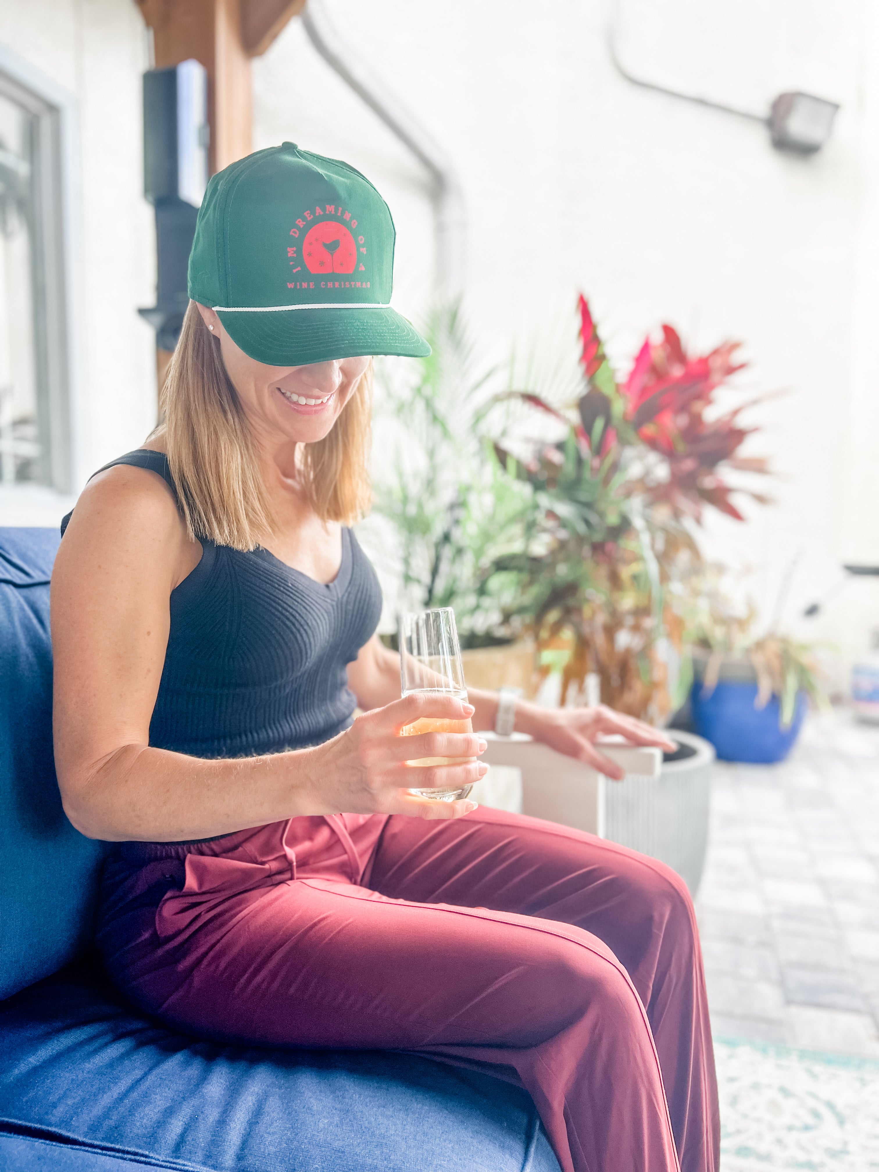 Red and green Christmas-themed hat  for wine lovers in holiday jungle that says im dreaming of a wine christmas  from corkie apparel